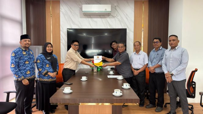 
 Ketua Komisi Infromasi Kepri Kepri Arison menyerahkan Laporan Akuntabilitas Kdan Kinerja Instansi Pemerintah (LAKIP) KI Kepri tahun 2025 kepada Kepala Dinas Komunikasi dan Indformasi Provinsi Kepri Hendri Kurniadi di Kantor Diskominfo Kepri, Dompak, Senin (27/4/2026). (Dokumen KI Kepri)